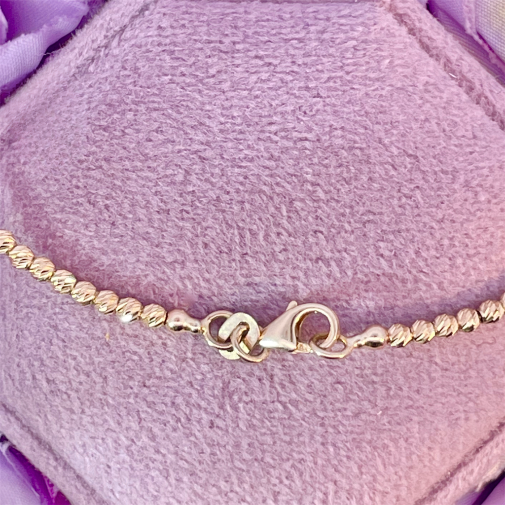 14K Diamond Cut Yellow Gold Beaded Flexi Bracelet with an Emerald Cut Mozambique Garnet