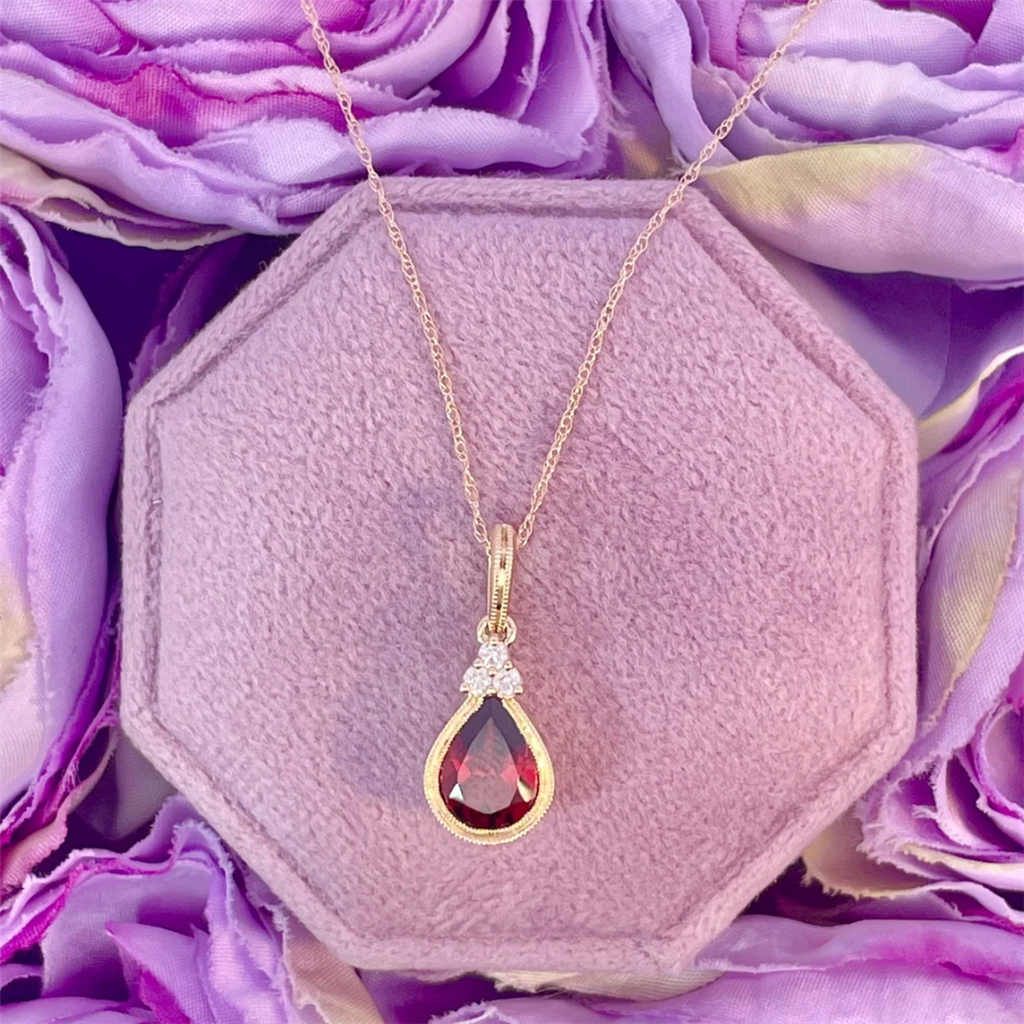 14K Yellow Gold Garnet Pendant with diamond accents on an 18" Rope Chain