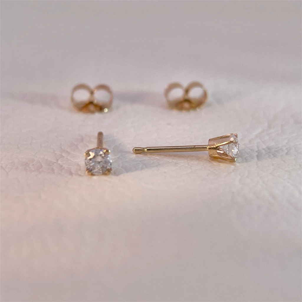 14K yellow gold diamond stud earrings with approximately .20ct of natural round diamonds.