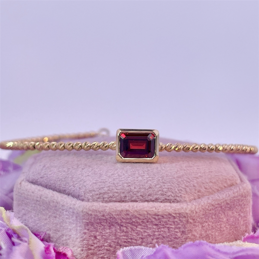 14K Diamond Cut Yellow Gold Beaded Flexi Bracelet with an Emerald Cut Mozambique Garnet