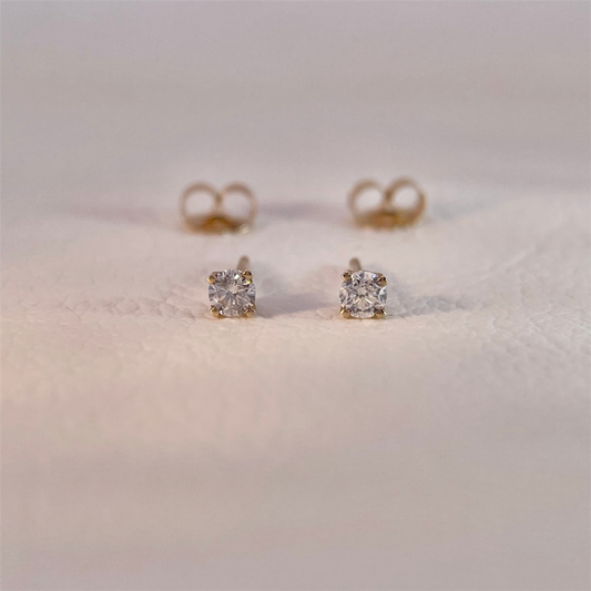 14K yellow gold diamond stud earrings with approximately .20ct of natural round diamonds.